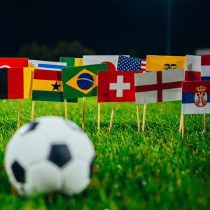 soccer ball with flags from different countries on a grass field