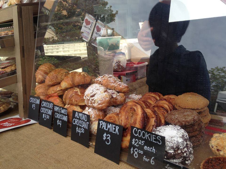 Variety of baked goods behind glass window.