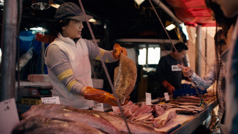 Woman selling seafood at Fisherman's Wharf in Steveston Village.