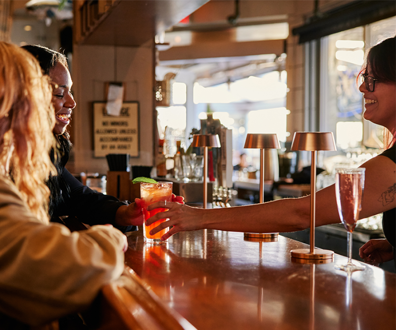 bar tender serving customers a Steveston Sips beverage